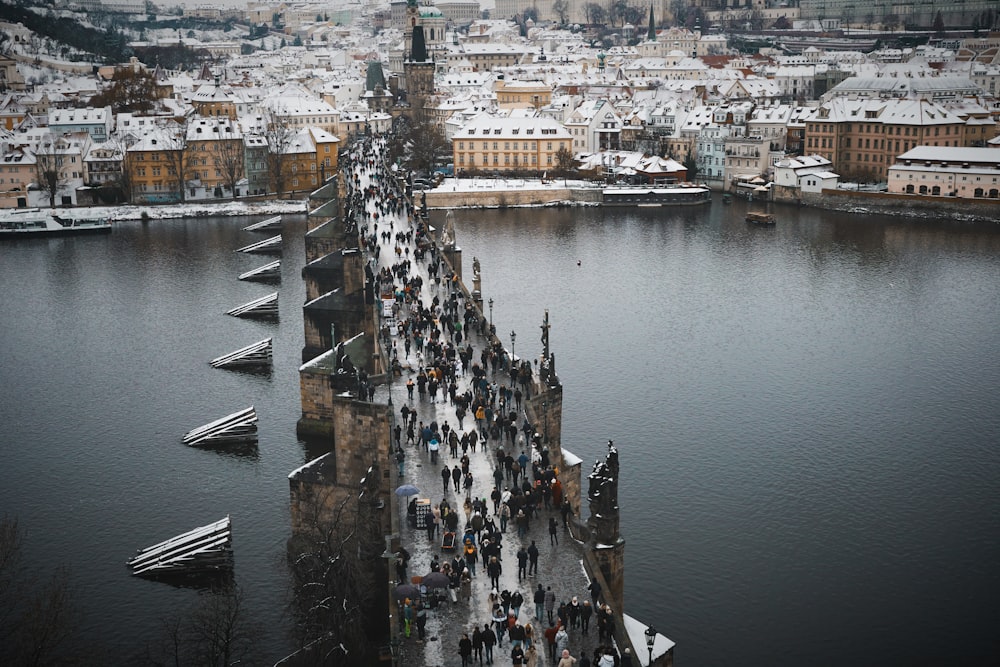 a large group of people walking across a bridge