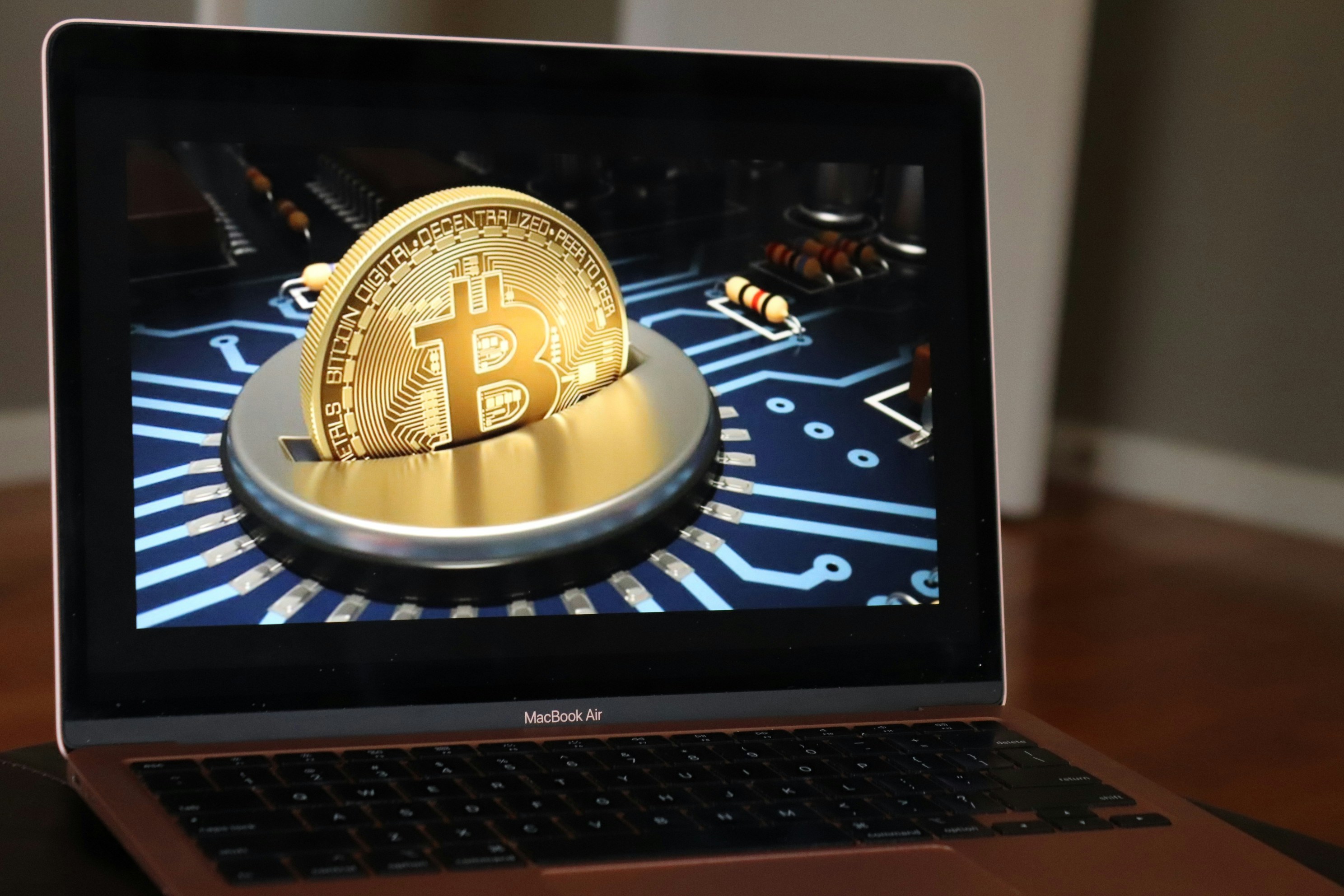Bitcoin design displayed on a rose gold MacBook Air.