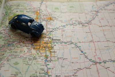 a toy car sitting on top of a map