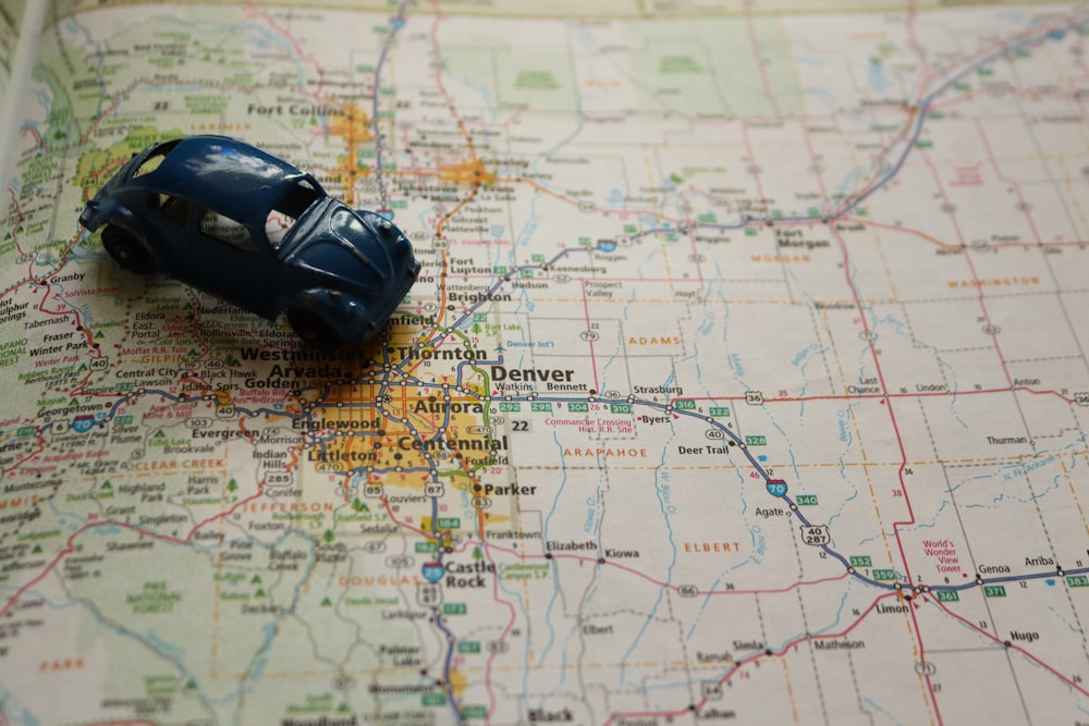 a toy car sitting on top of a map