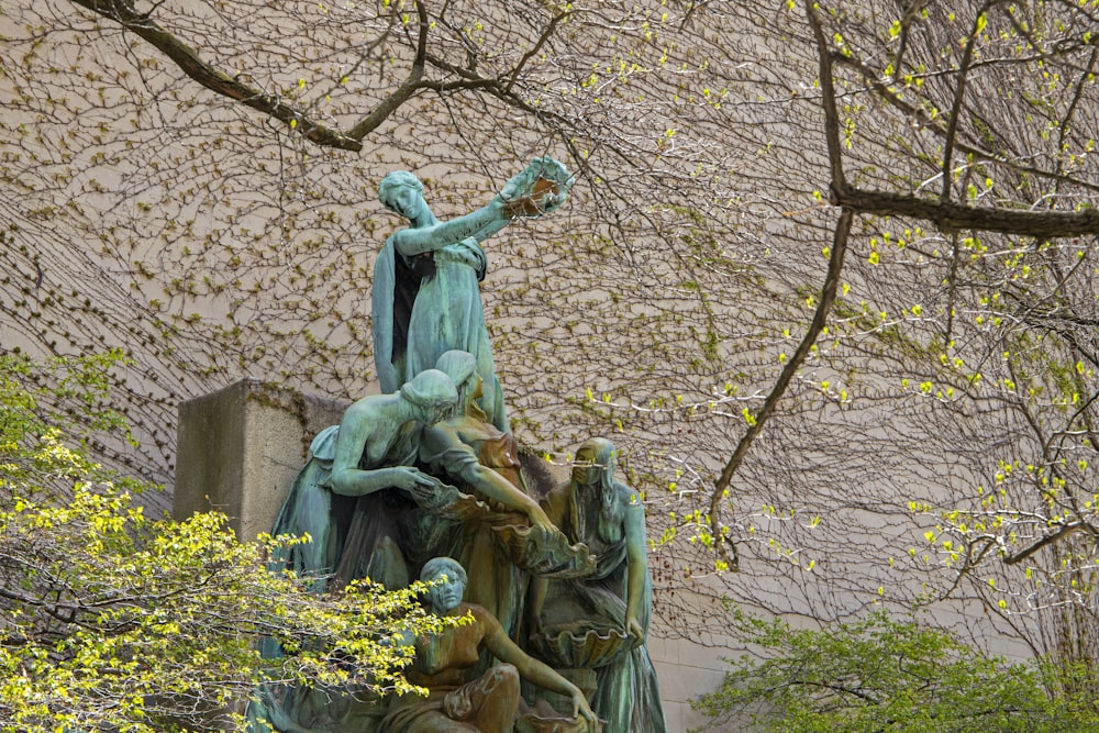 a statue of a group of people holding a cross