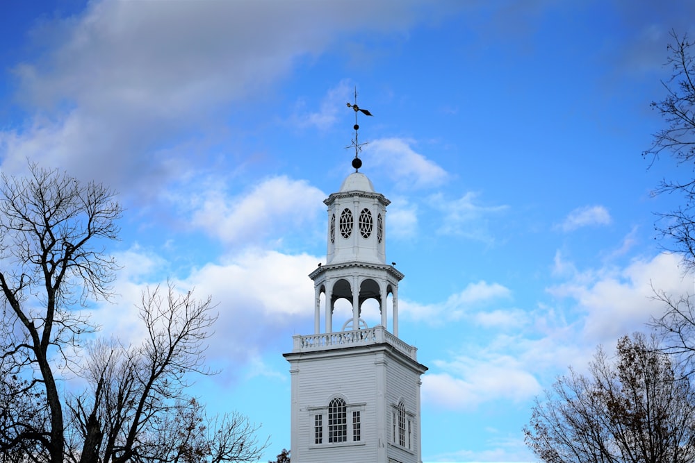 a tall white building with a clock on the top of it