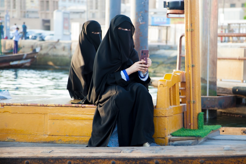 a couple of women sitting on top of a boat