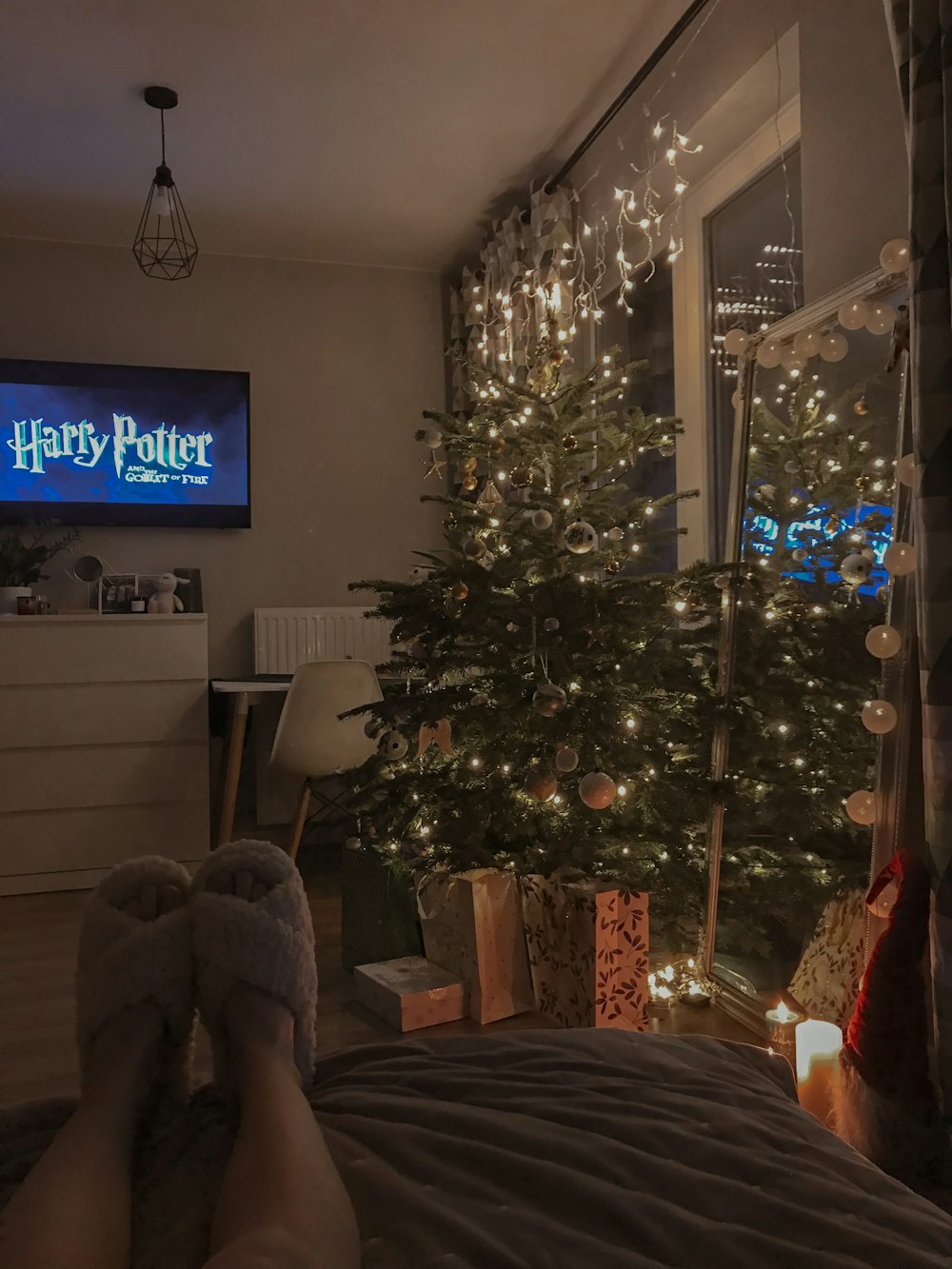 a bedroom with a christmas tree in the corner