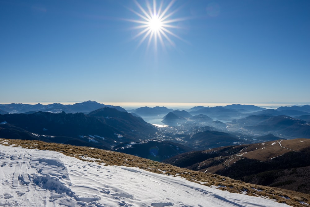 the sun shines brightly over a snowy mountain