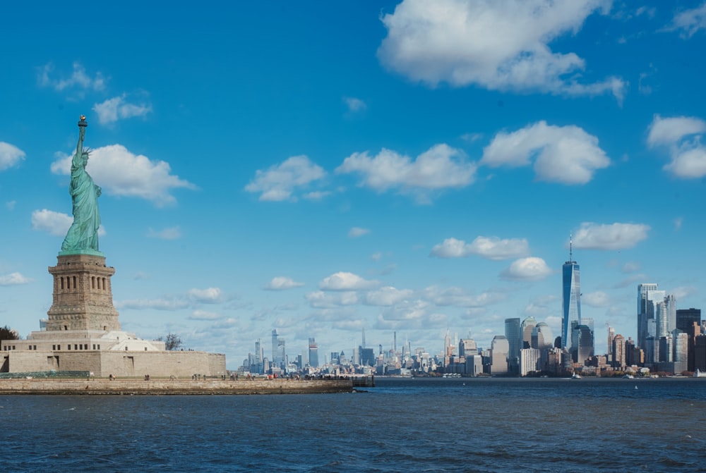 a large body of water with a statue of liberty in the background