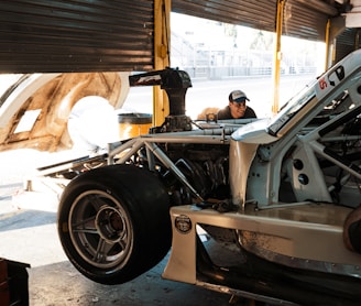 a man working on a car in a garage