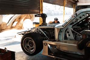 a man working on a car in a garage