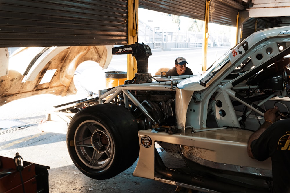 a man working on a car in a garage