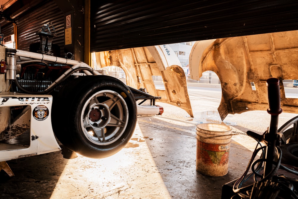 a car is parked under a wooden structure