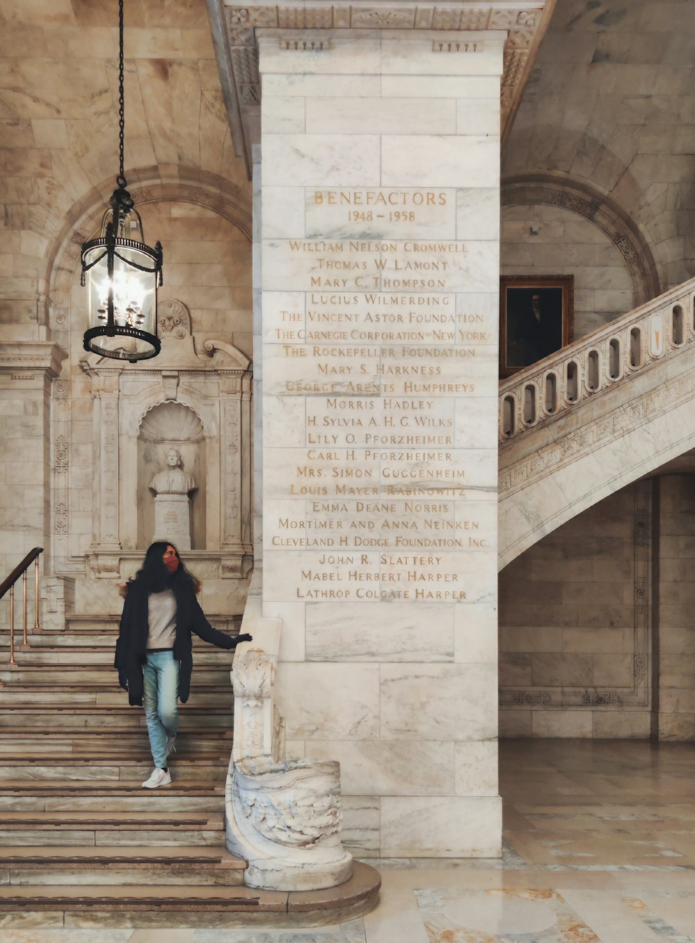 a woman standing on the steps of a building