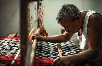 a man is working on a weaving machine