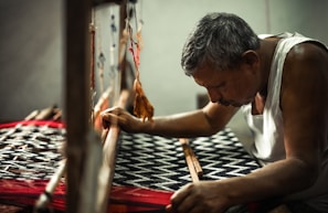 a man is working on a weaving machine