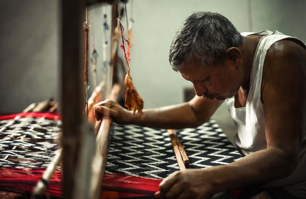 a man is working on a weaving machine