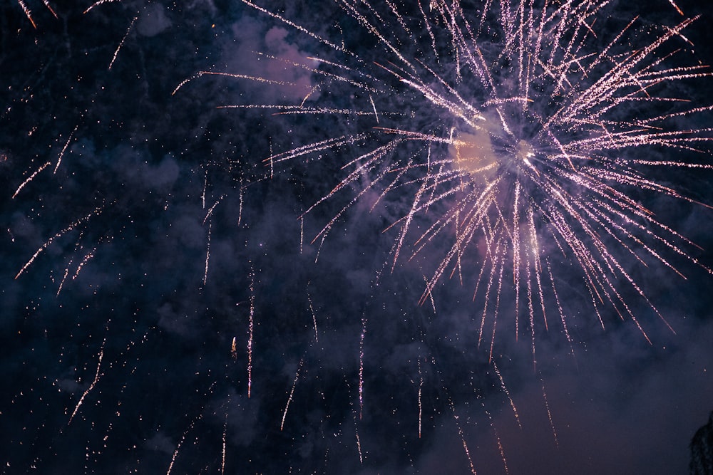 a large fireworks is lit up in the night sky