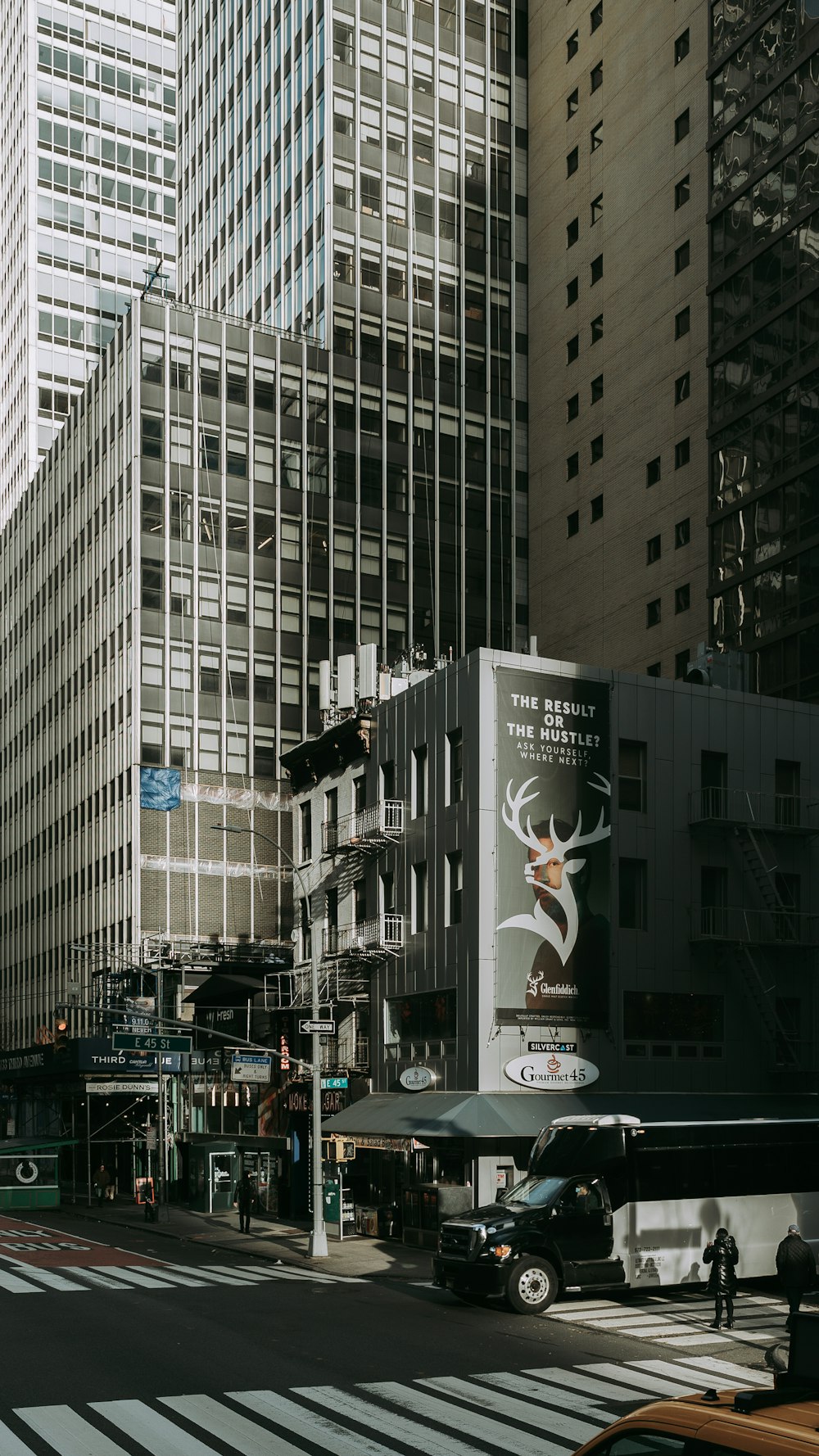 a city street with tall buildings in the background