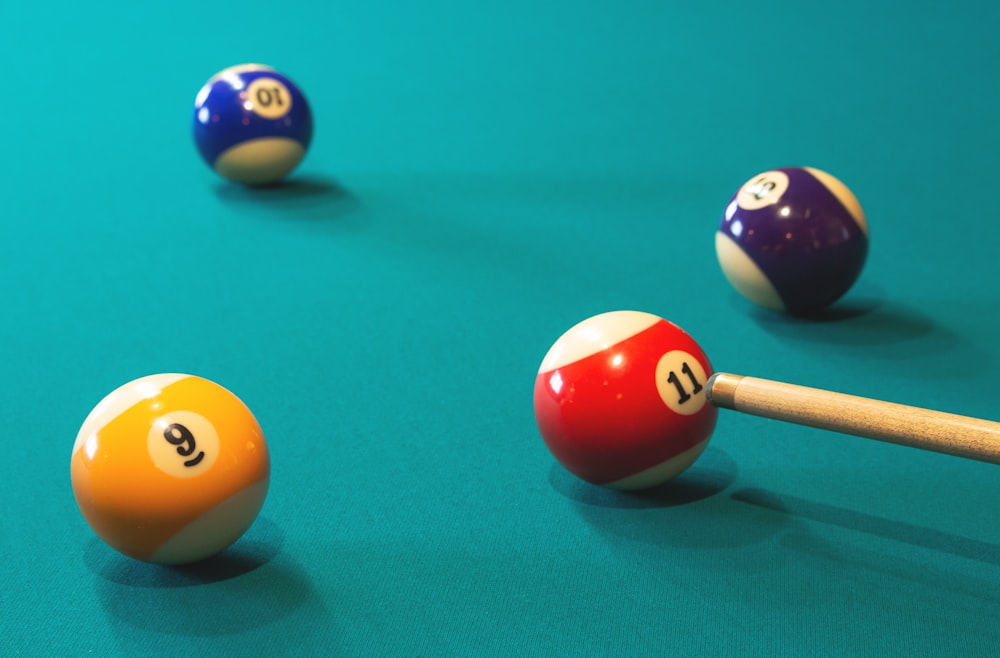 a pool table with pool balls and a cue