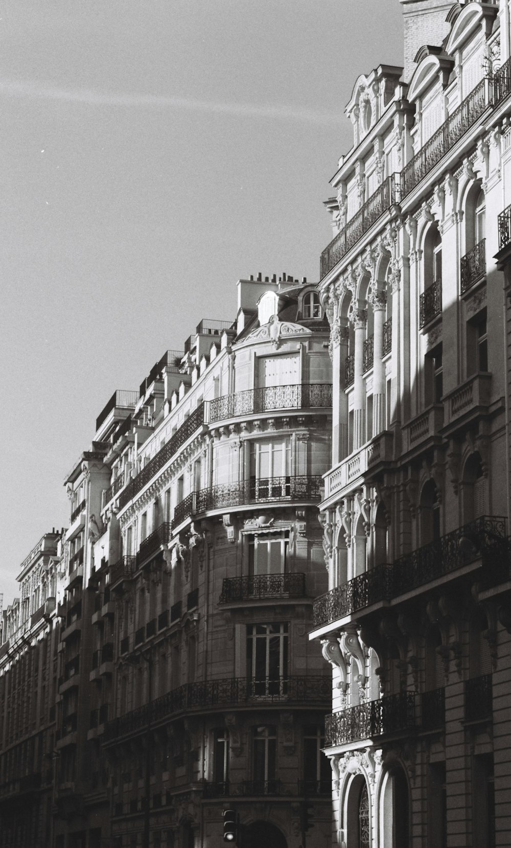 a black and white photo of a building with a clock