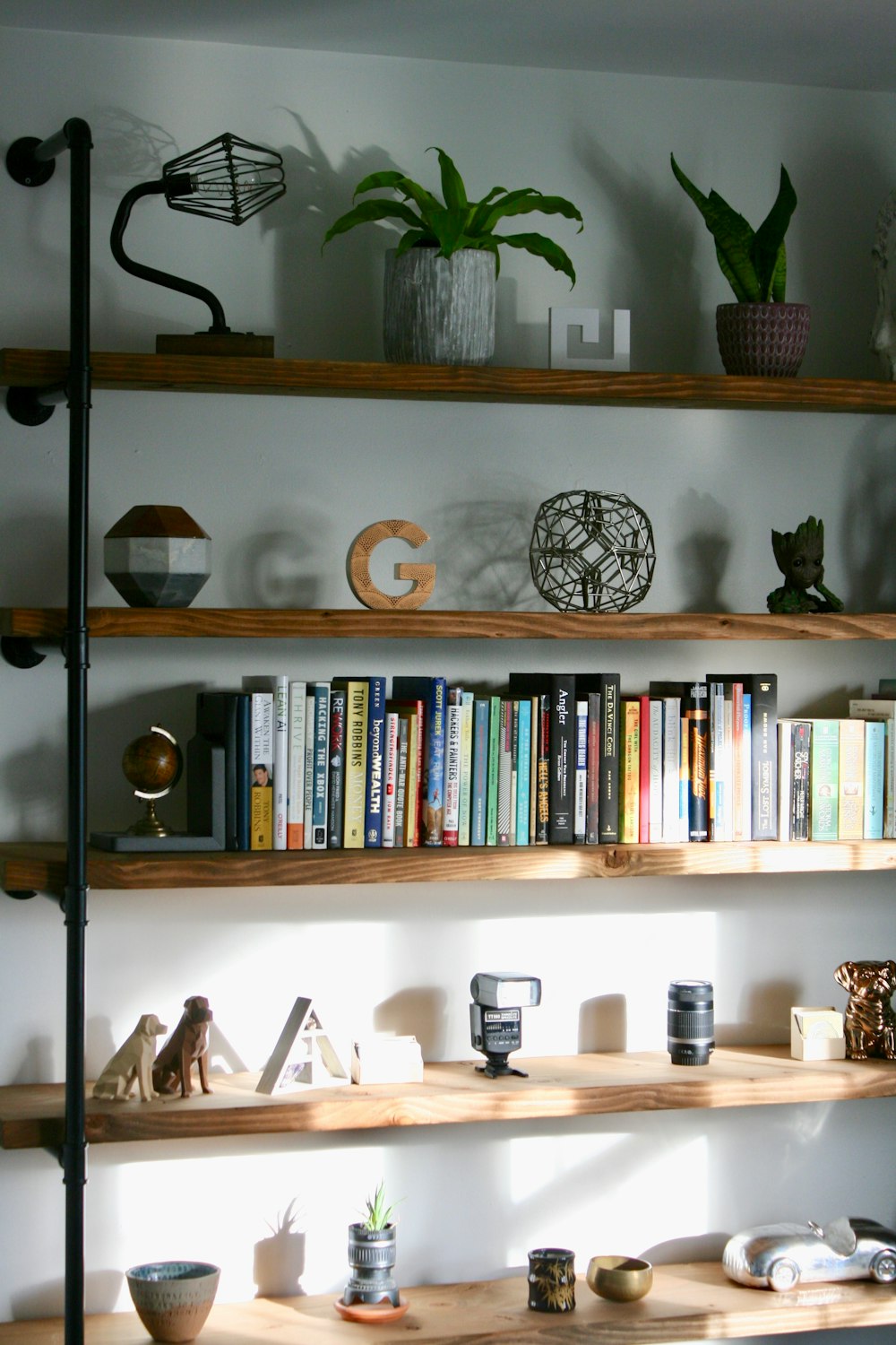 a bookshelf filled with lots of books on top of wooden shelves