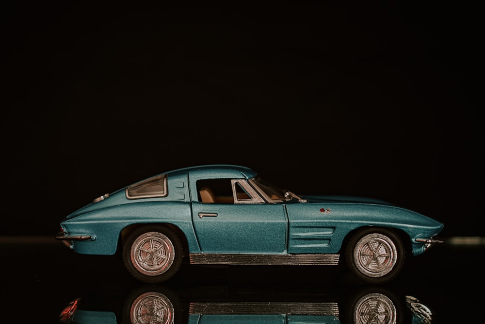 a blue toy car sitting on top of a table