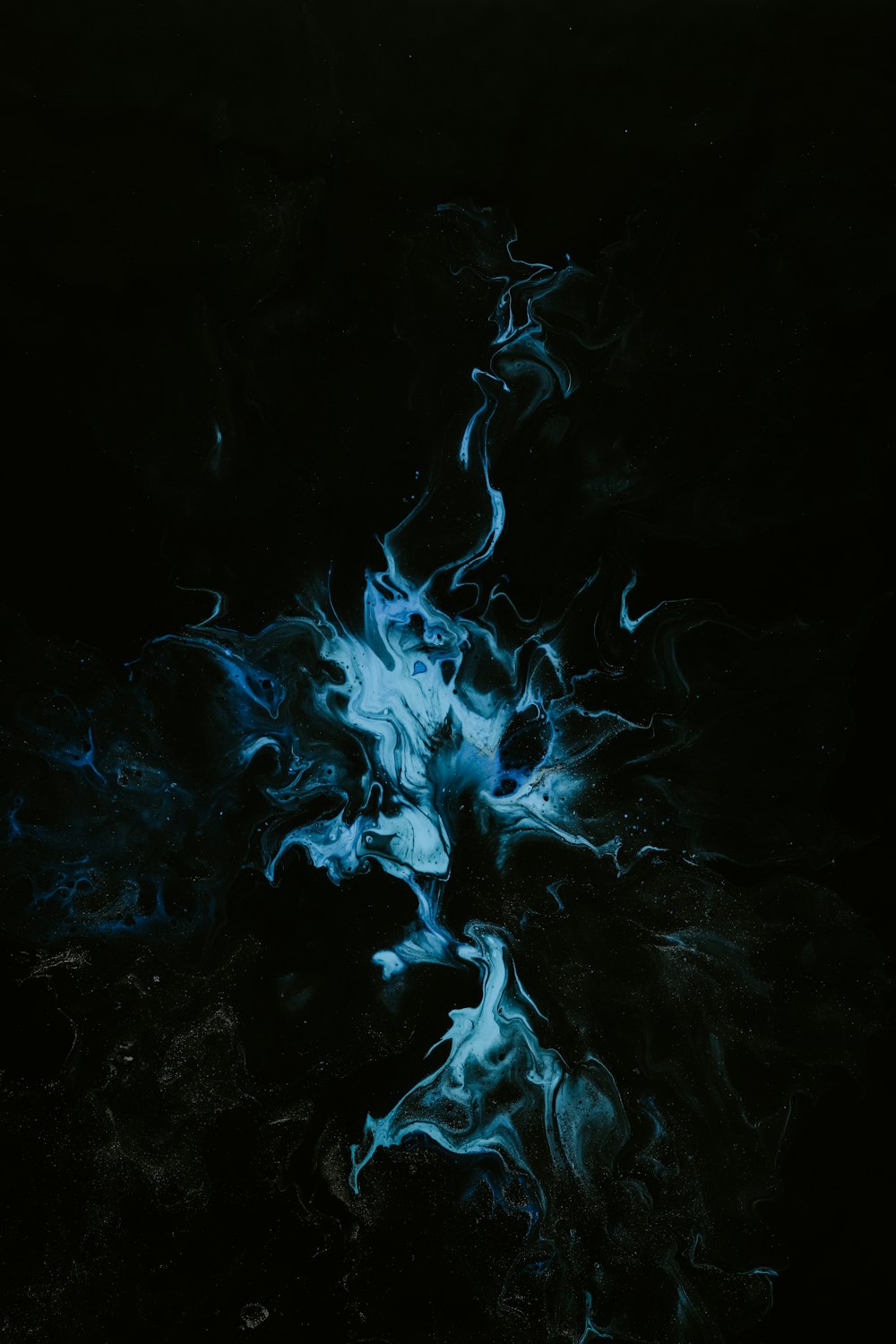 a black background with blue smoke coming out of it