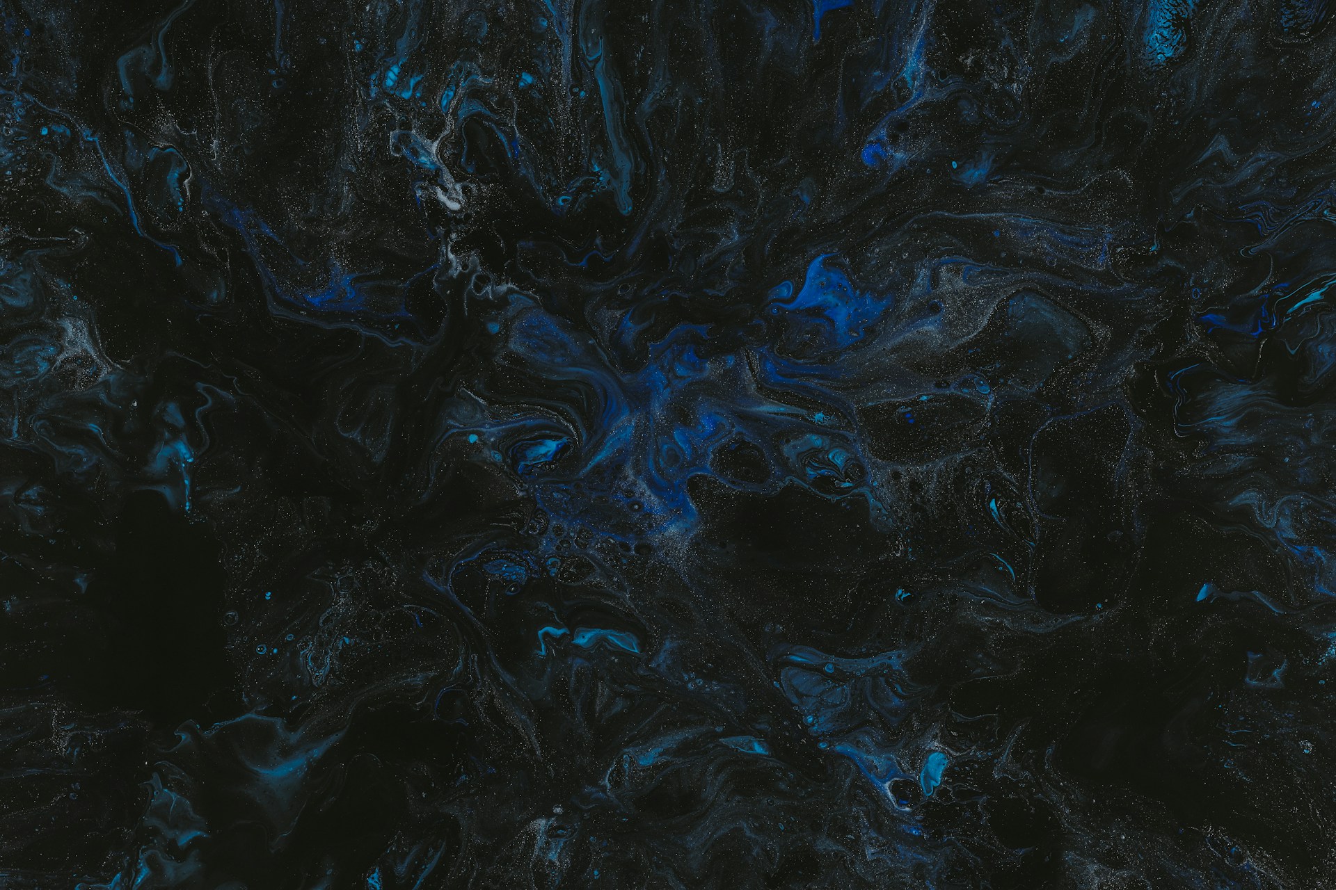 a black and blue background with a lot of black and blue swirls