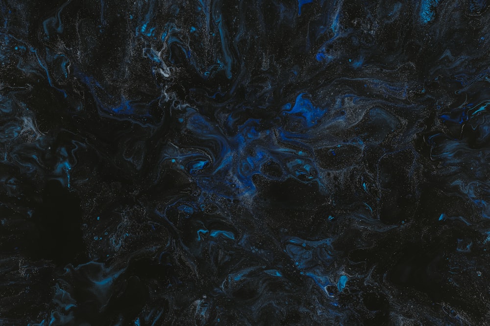 a black and blue background with a lot of black and blue swirls