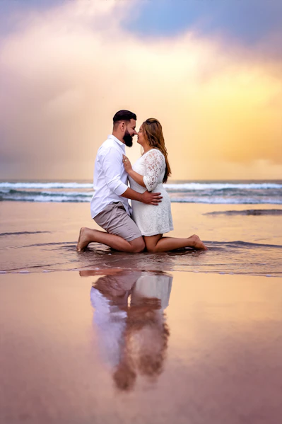 a man and a woman are sitting on the beach