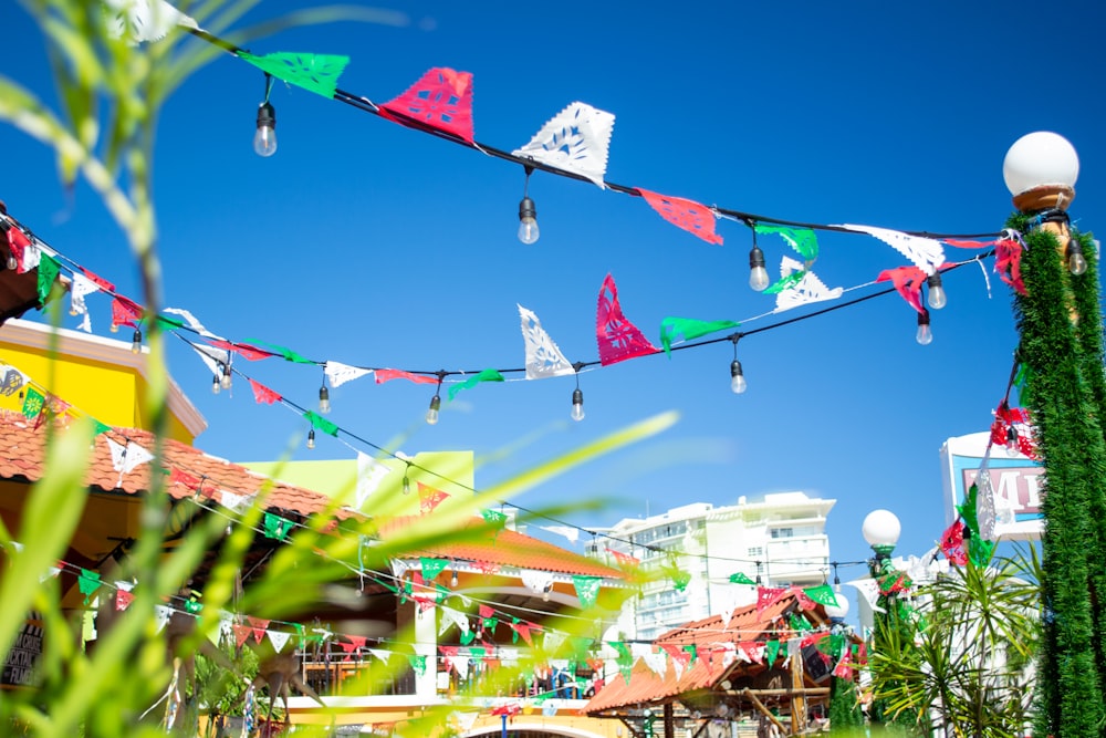 a bunch of colorful flags hanging from a line