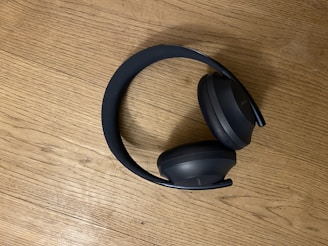 a pair of headphones sitting on top of a wooden table