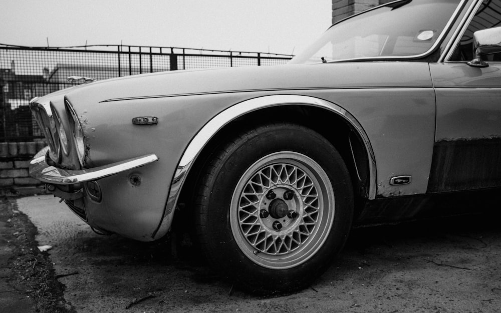 a black and white photo of an old car