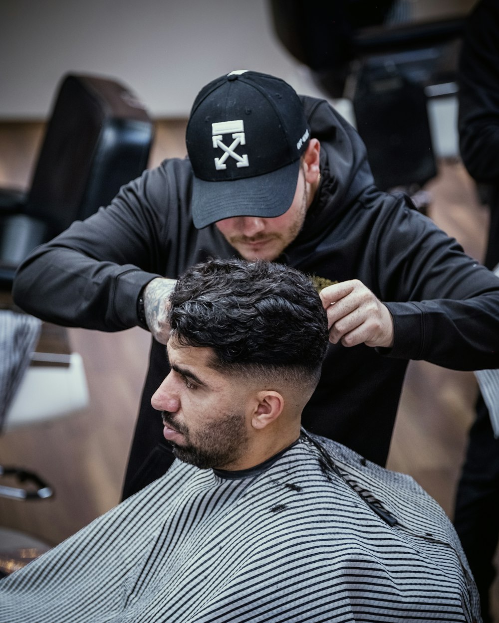 a man getting his hair cut at a barber shop