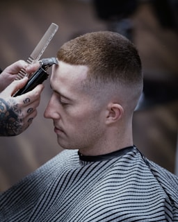 a man getting his hair cut by a barber