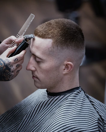 a man getting his hair cut by a barber