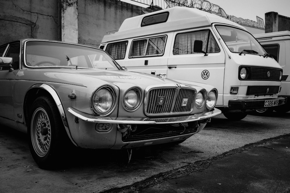 a black and white photo of a car and a bus