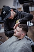 a man getting his hair cut at a barber shop