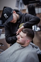a man getting his hair cut at a barber shop