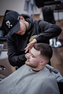 a man getting his hair cut at a barber shop