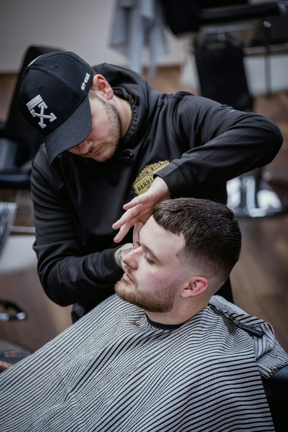 a man getting his hair cut at a barber shop