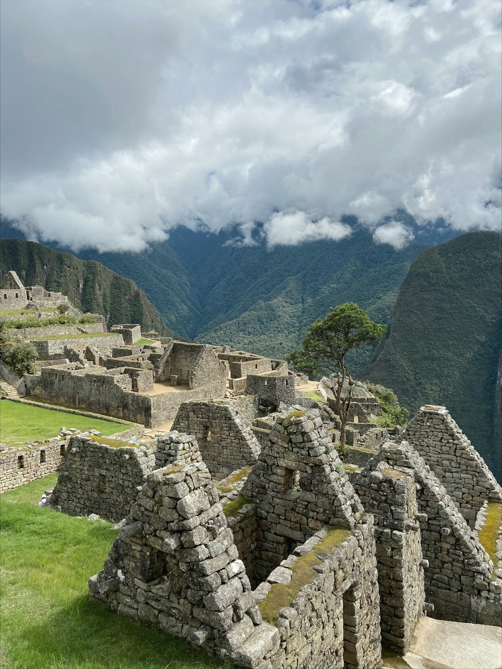 a view of a mountain range with ruins in the foreground