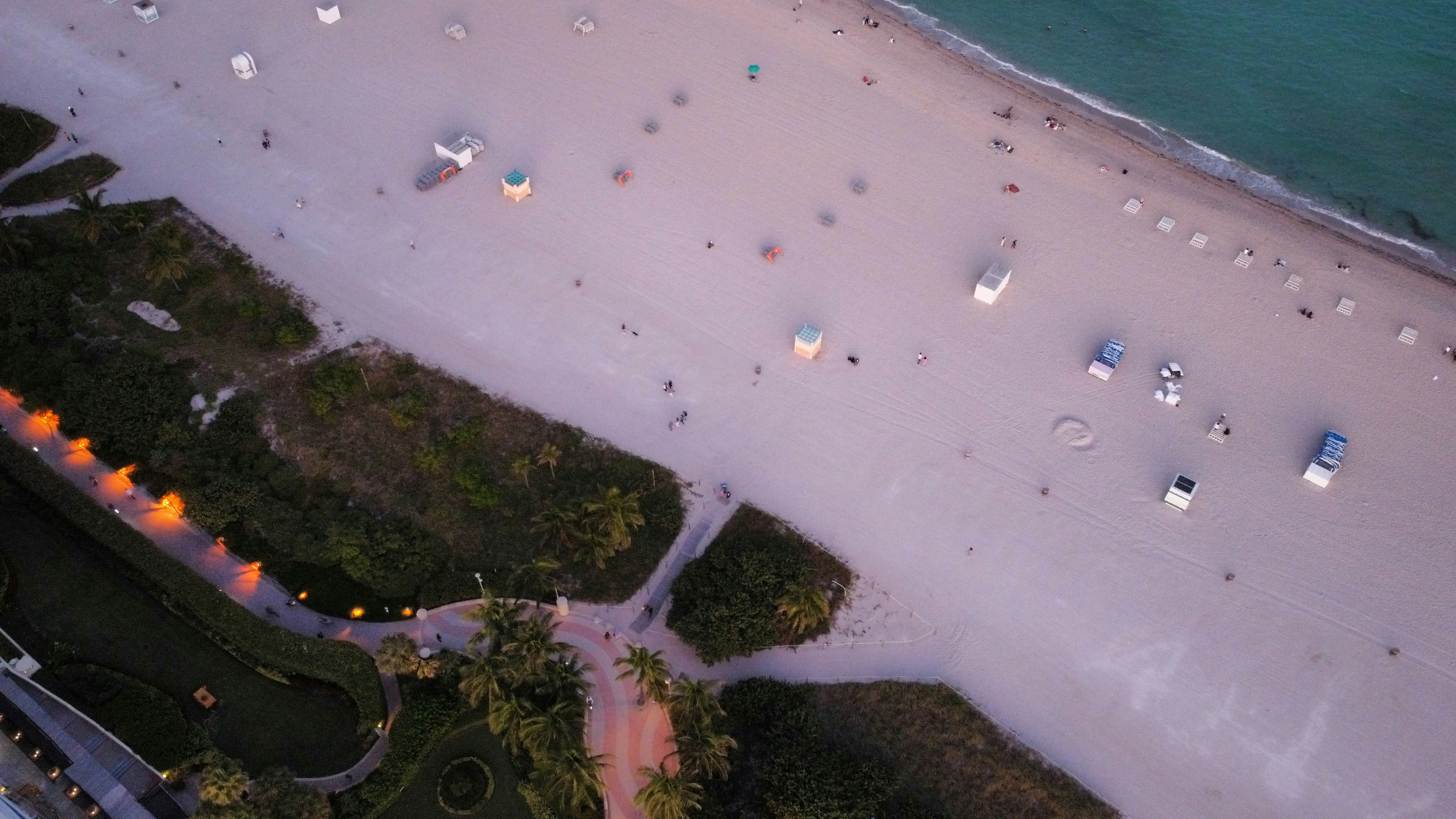 an aerial view of a beach at dusk