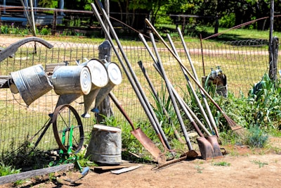 an old fashioned water pump sitting next to a fence