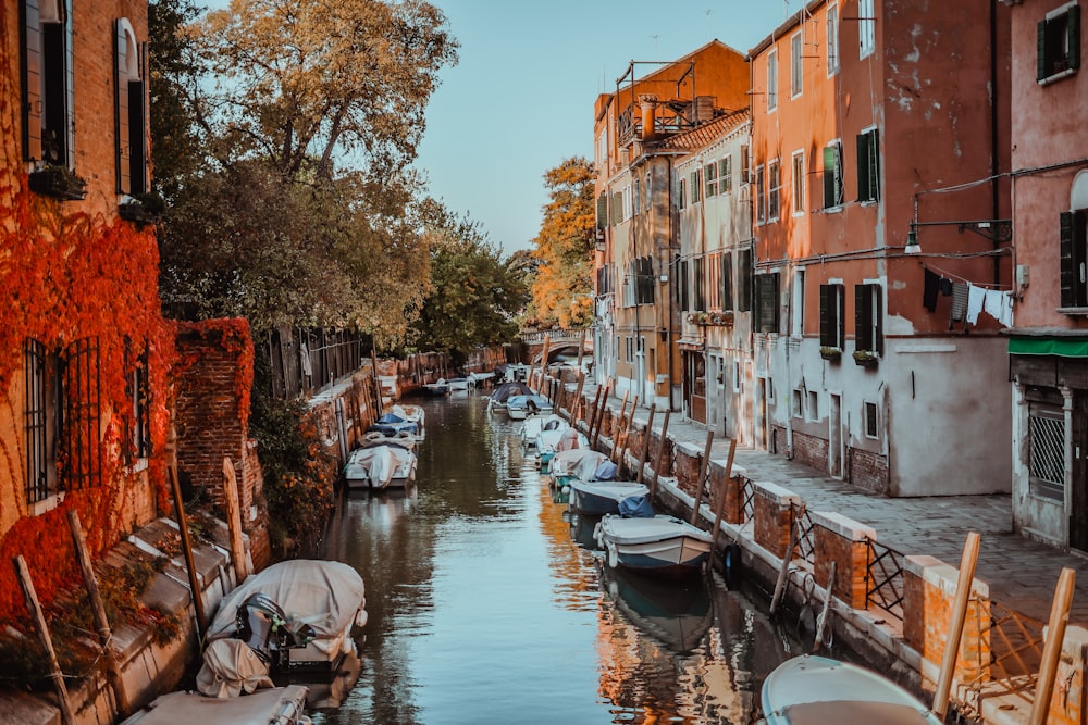 several boats are parked along the side of a canal