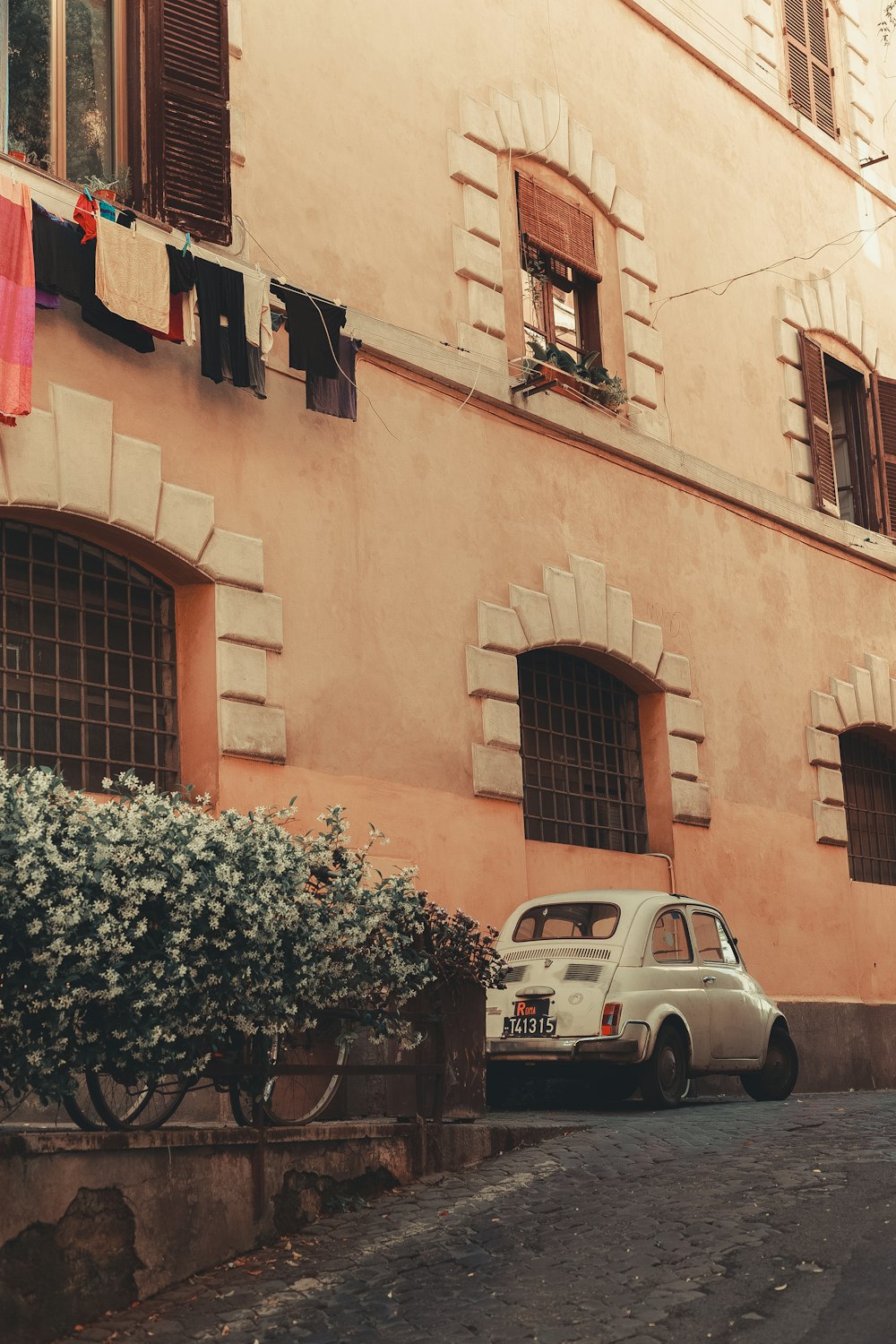 a white car parked in front of a building