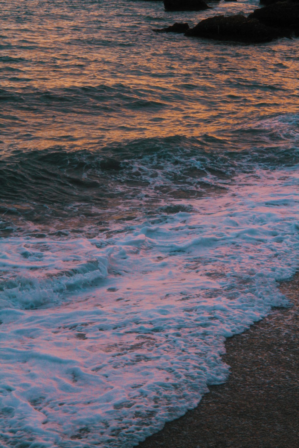 a beach with waves coming in to shore