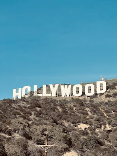 a large hollywood sign on a hill with a blue sky in the background