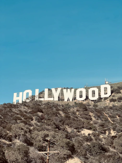 a large hollywood sign on a hill with a blue sky in the background
