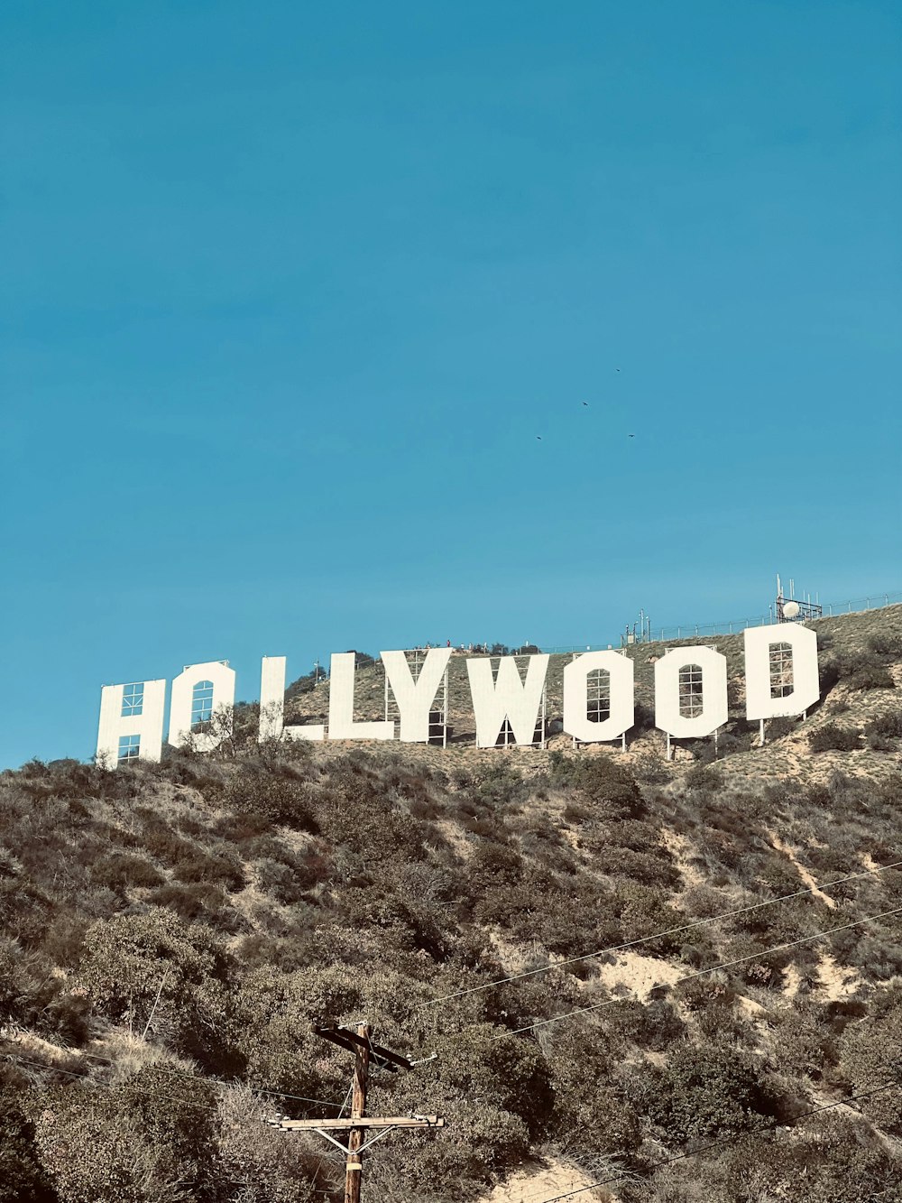 a large hollywood sign on a hill with a blue sky in the background