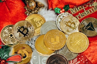 a pile of gold and silver coins sitting on top of a red blanket
