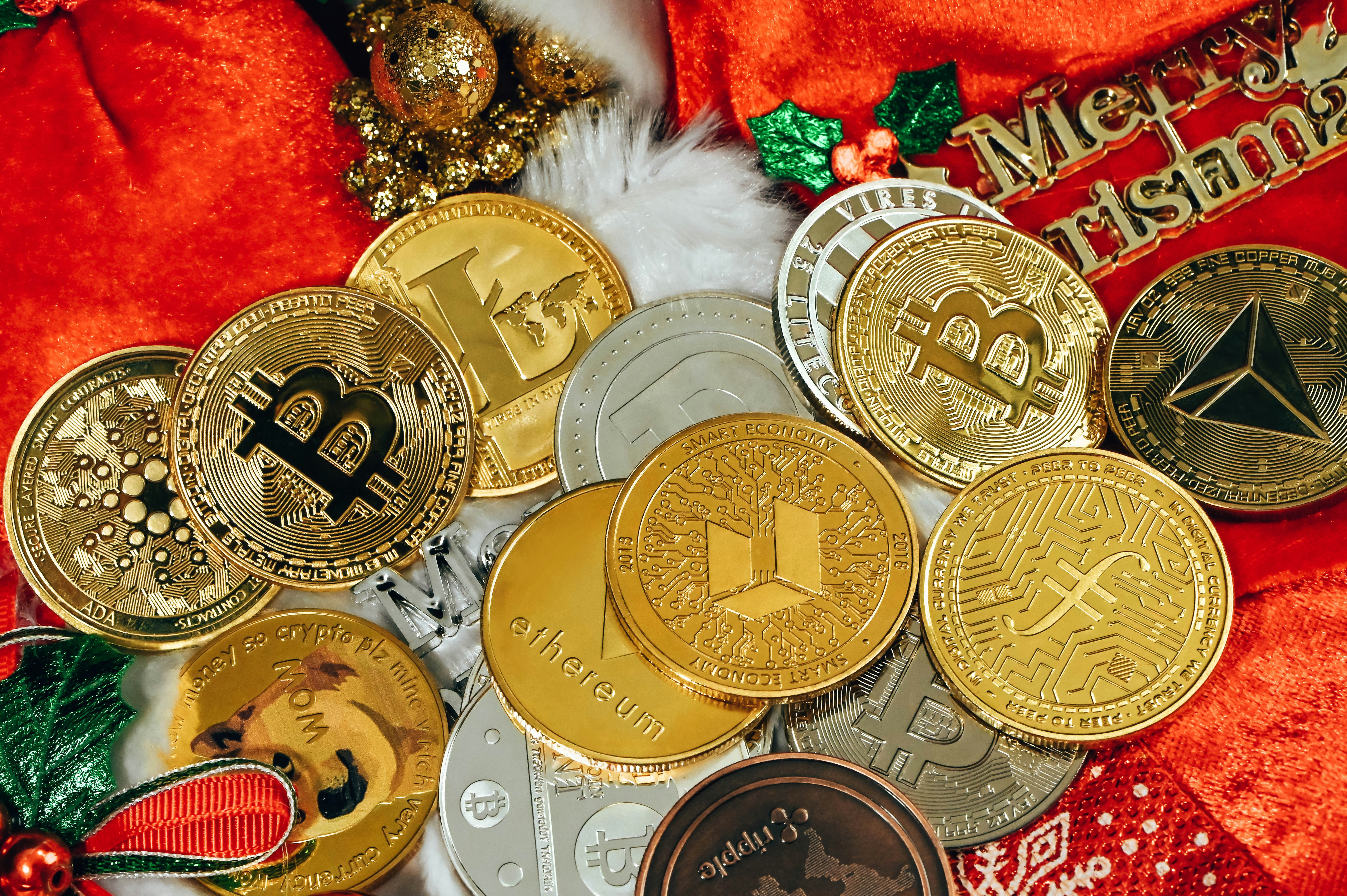 A pile of cryptocurrency coins are together on Christmas background